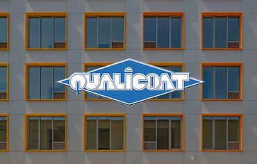 Qualicoat logo in front of colourful windows.